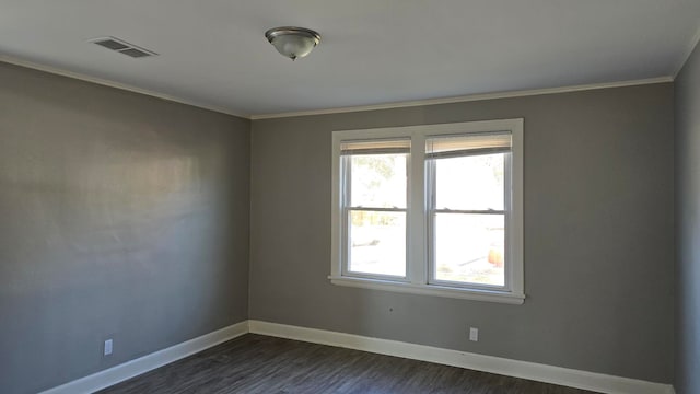 spare room with dark hardwood / wood-style floors and ornamental molding