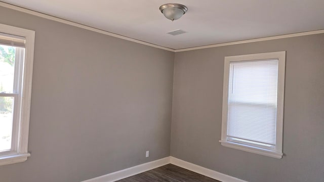 spare room with dark wood-type flooring and ornamental molding