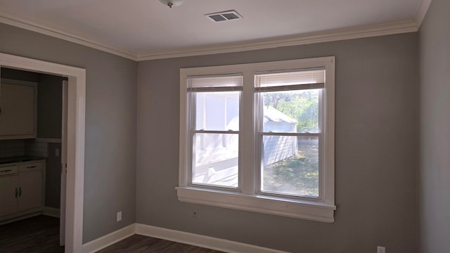 empty room featuring dark hardwood / wood-style floors and crown molding