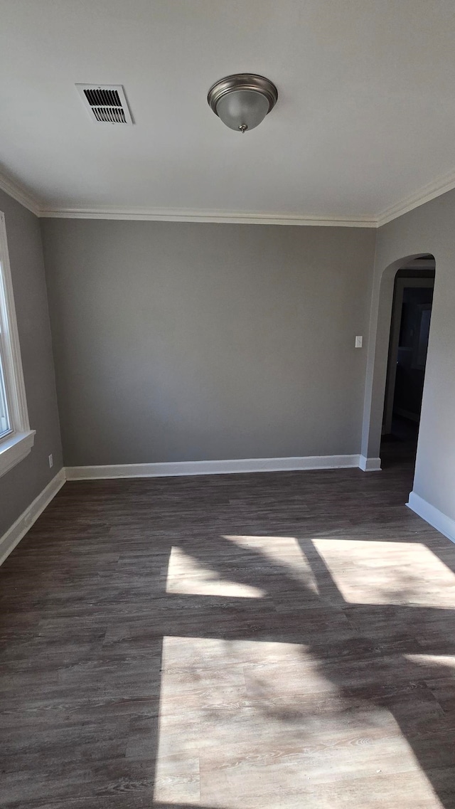 unfurnished room featuring crown molding and dark hardwood / wood-style flooring