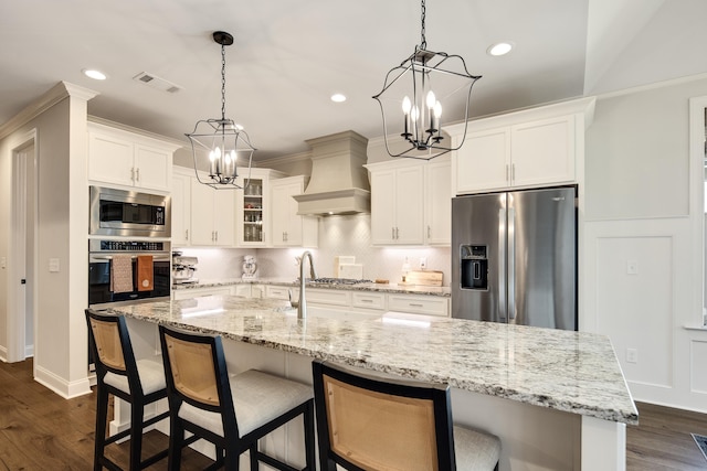 kitchen featuring dark hardwood / wood-style flooring, white cabinets, custom exhaust hood, and appliances with stainless steel finishes