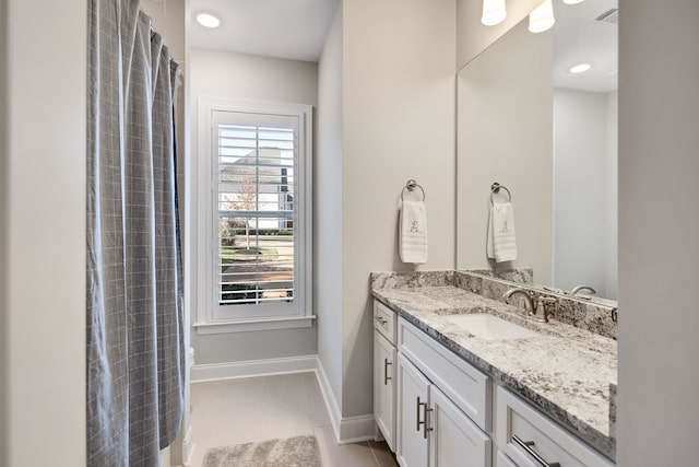 bathroom featuring tile patterned flooring and vanity