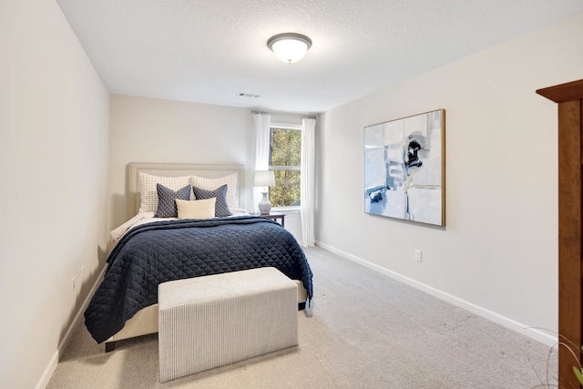 bedroom featuring carpet and a textured ceiling