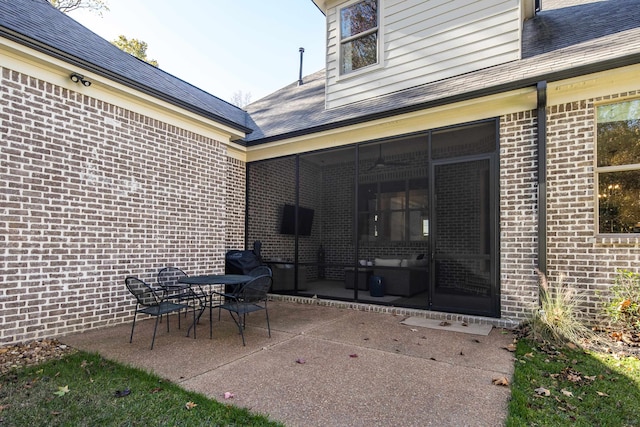 view of patio featuring a sunroom