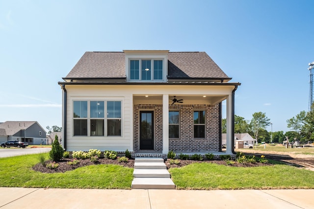 bungalow-style house featuring roof with shingles, a ceiling fan, and brick siding