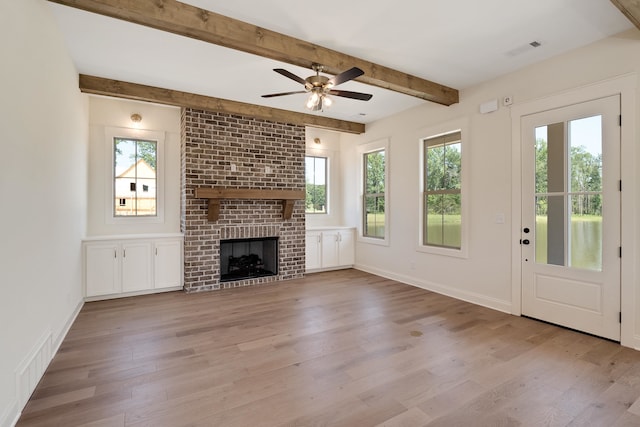 unfurnished living room featuring light wood-type flooring and a wealth of natural light