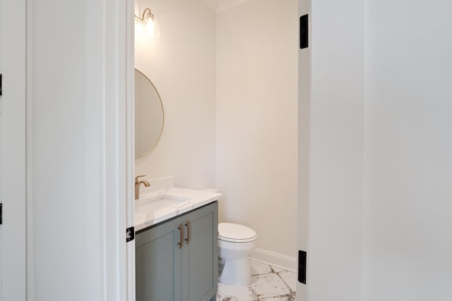 bathroom with tile patterned flooring, vanity, and toilet