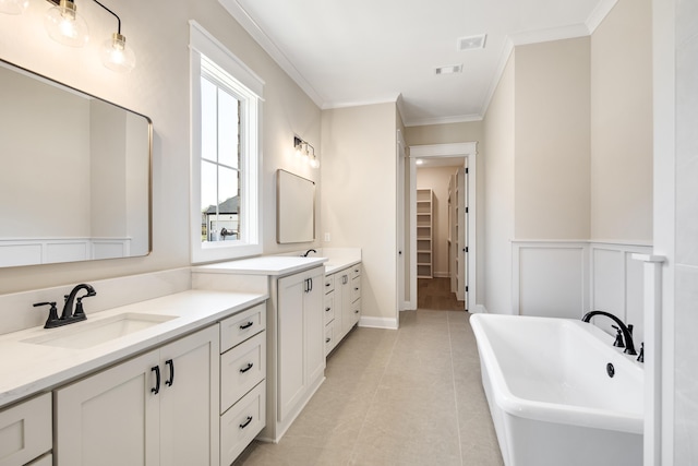 520 Valley Forge Ln, Rossville, TN 38066 - full bathroom featuring two vanities, crown molding, a soaking tub, tile patterned floors, and a walk in closet