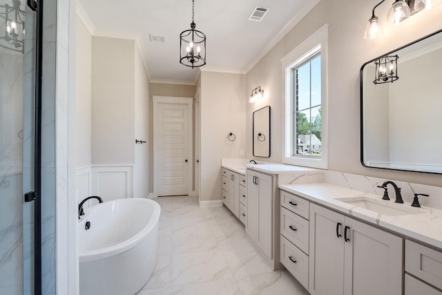 bathroom featuring vanity, an inviting chandelier, ornamental molding, and a tub