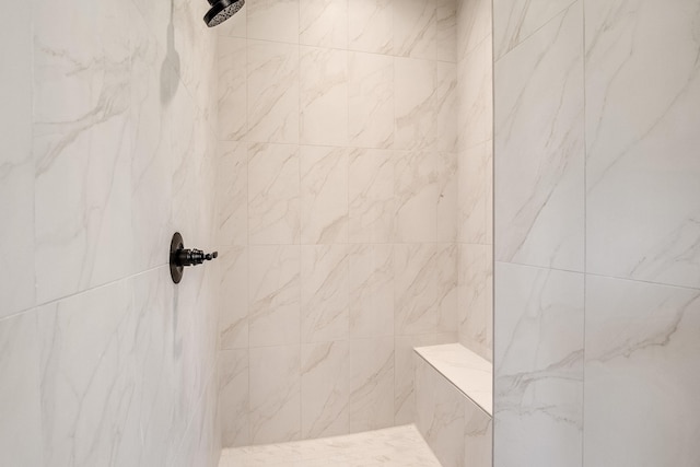 bathroom with a tile shower