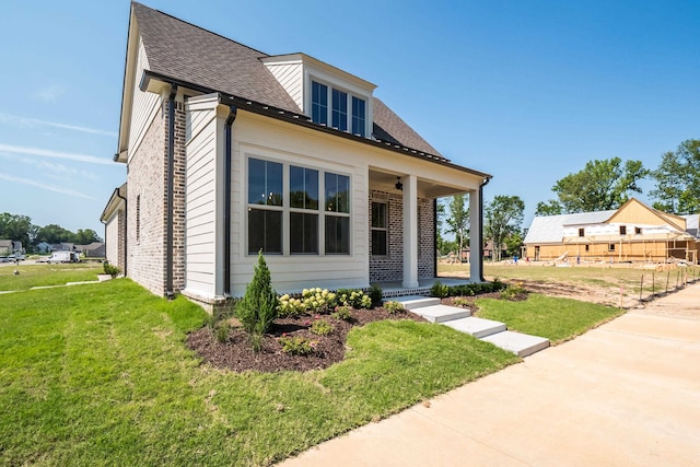 view of front of house featuring a porch and a front yard