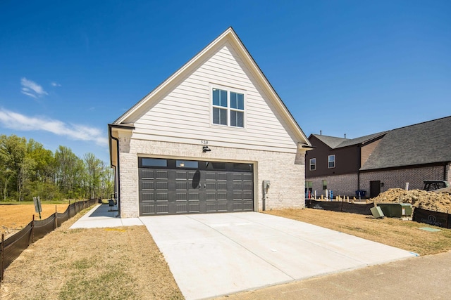 520 Valley Forge Ln, Rossville, TN 38066 - view of side of home with driveway, an attached garage, brick siding, and a lawn
