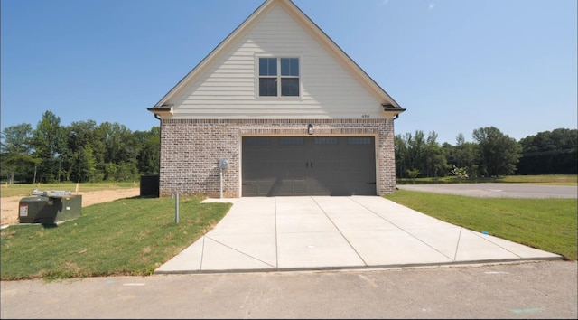 view of front of home with a garage and a front lawn