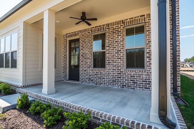 entrance to property with a porch and ceiling fan