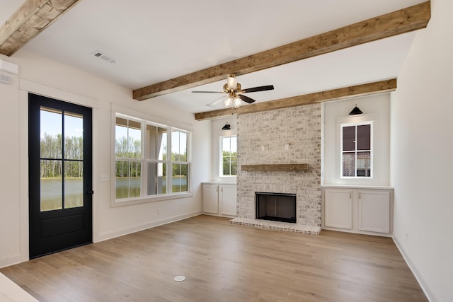 520 Valley Forge Ln, Rossville, TN 38066 - unfurnished living room featuring wood finished floors, beam ceiling, a ceiling fan, a fireplace, and baseboards