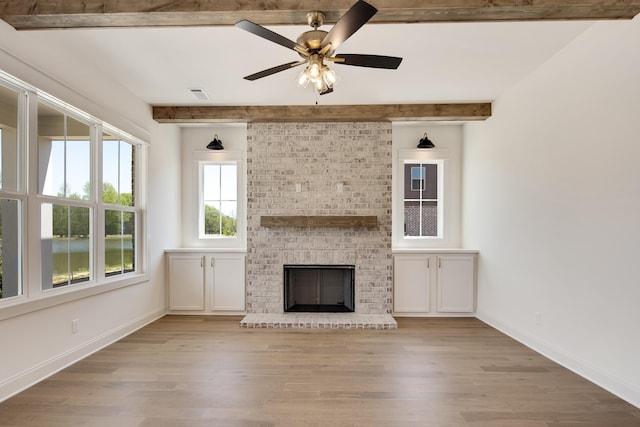 520 Valley Forge Ln, Rossville, TN 38066 - unfurnished living room featuring beam ceiling, wood finished floors, a brick fireplace, ceiling fan, and baseboards