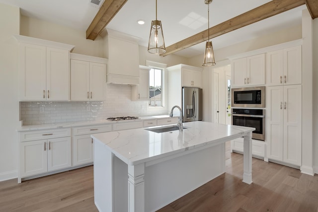 kitchen with sink, hanging light fixtures, beamed ceiling, white cabinets, and appliances with stainless steel finishes