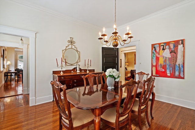 dining room with crown molding, hardwood / wood-style floors, and an inviting chandelier