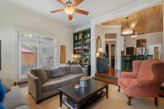 living room featuring ceiling fan, built in features, crown molding, hardwood / wood-style floors, and wood ceiling