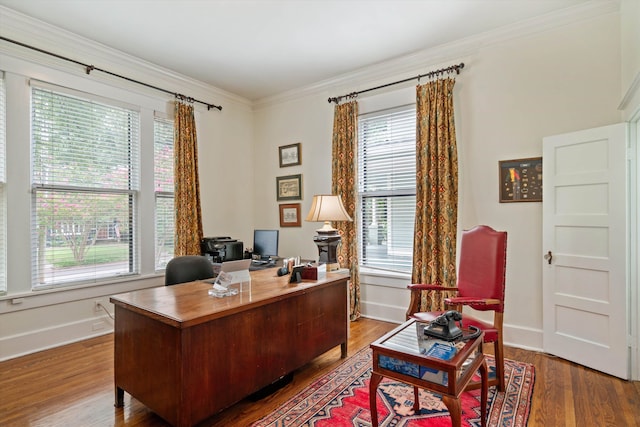 home office featuring hardwood / wood-style flooring, a wealth of natural light, and crown molding