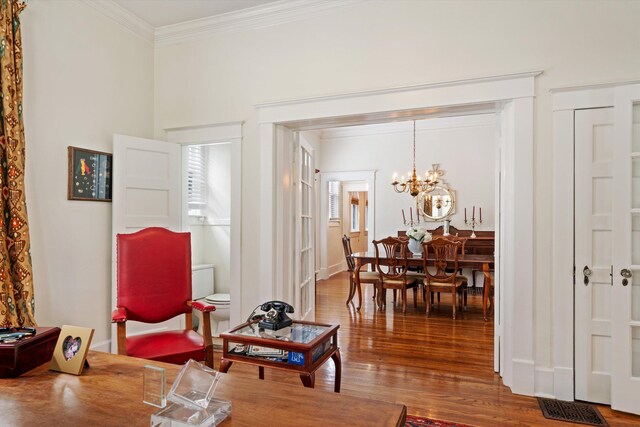 1876 Cowden Ave, Memphis, TN 38104 - living area with crown molding, a chandelier, and wood finished floors