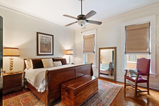 bedroom with ceiling fan, dark hardwood / wood-style flooring, and crown molding