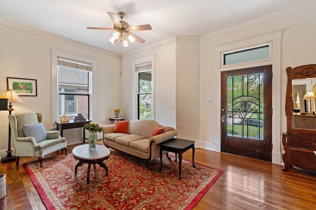 living room with ceiling fan, wood-type flooring, and crown molding