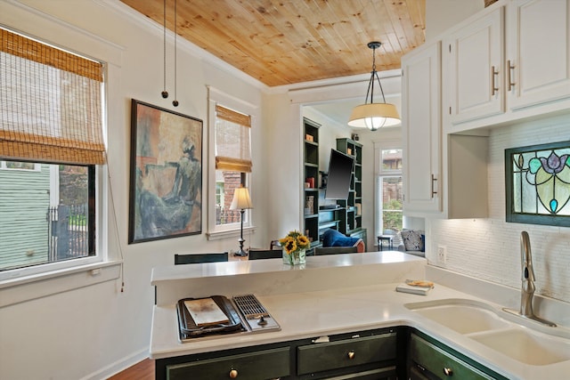 kitchen with pendant lighting, plenty of natural light, white cabinetry, and sink