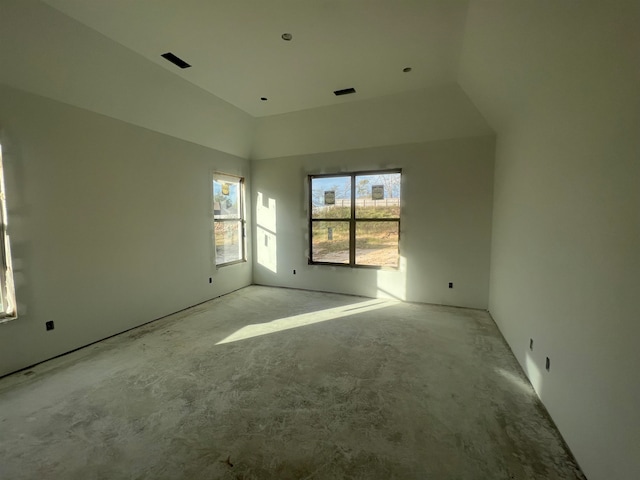 spare room featuring lofted ceiling