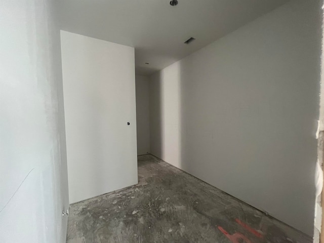 unfurnished room with concrete floors