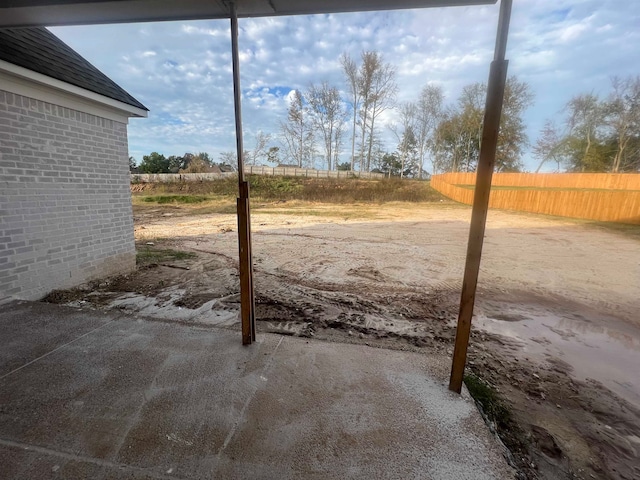 view of yard featuring fence and a patio