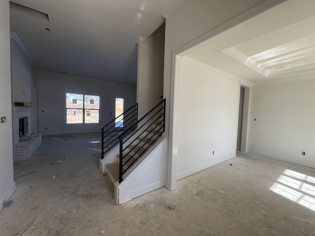 stairway featuring a fireplace and crown molding