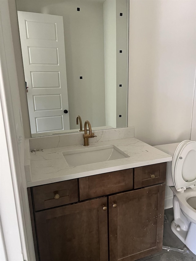 bathroom featuring toilet and vanity