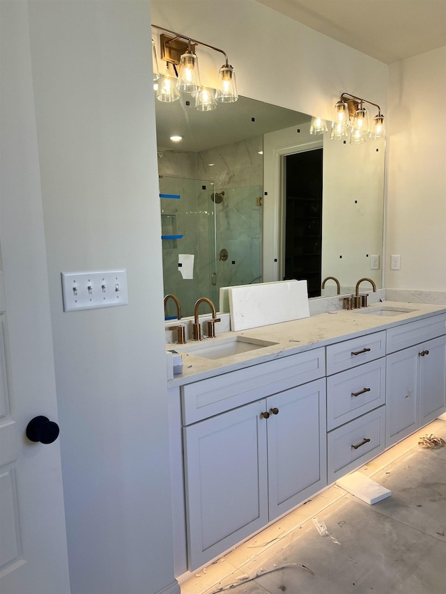 bathroom with double vanity, a shower stall, and a sink