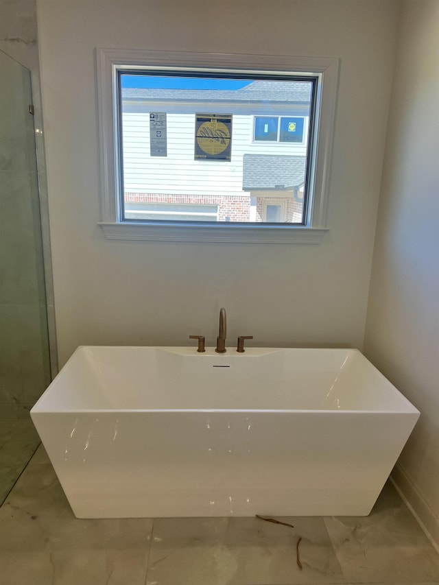 full bathroom featuring a freestanding tub and a shower