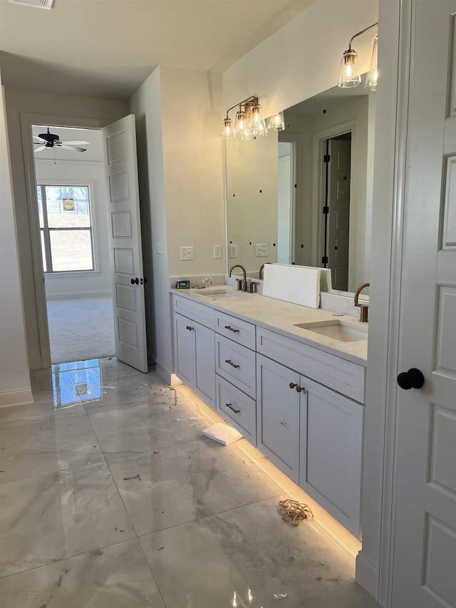 full bath with double vanity, marble finish floor, visible vents, and a sink