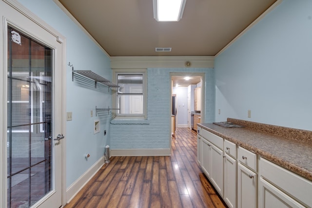 laundry area featuring cabinets, washer hookup, dark hardwood / wood-style flooring, hookup for an electric dryer, and ornamental molding