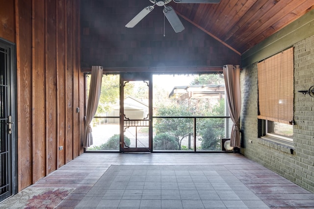 unfurnished sunroom featuring ceiling fan, wooden ceiling, and vaulted ceiling