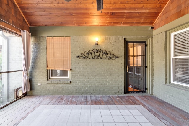 unfurnished sunroom with lofted ceiling and wood ceiling