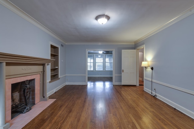 unfurnished living room with a fireplace, hardwood / wood-style floors, built in features, and ornamental molding