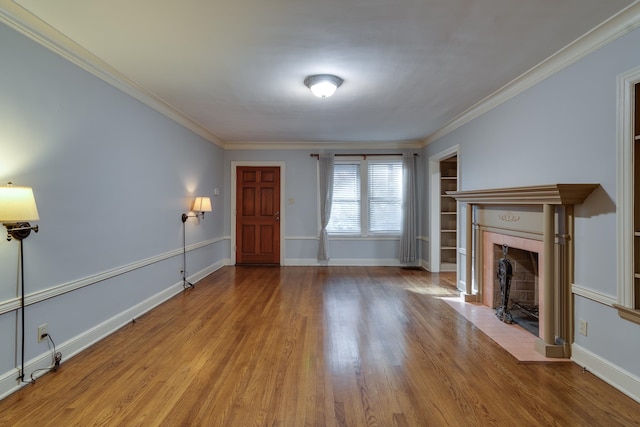 unfurnished living room with crown molding and light hardwood / wood-style floors