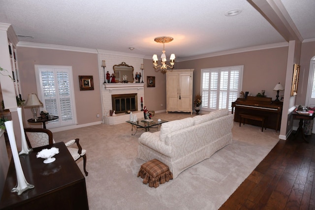 living room with hardwood / wood-style floors, crown molding, and a fireplace