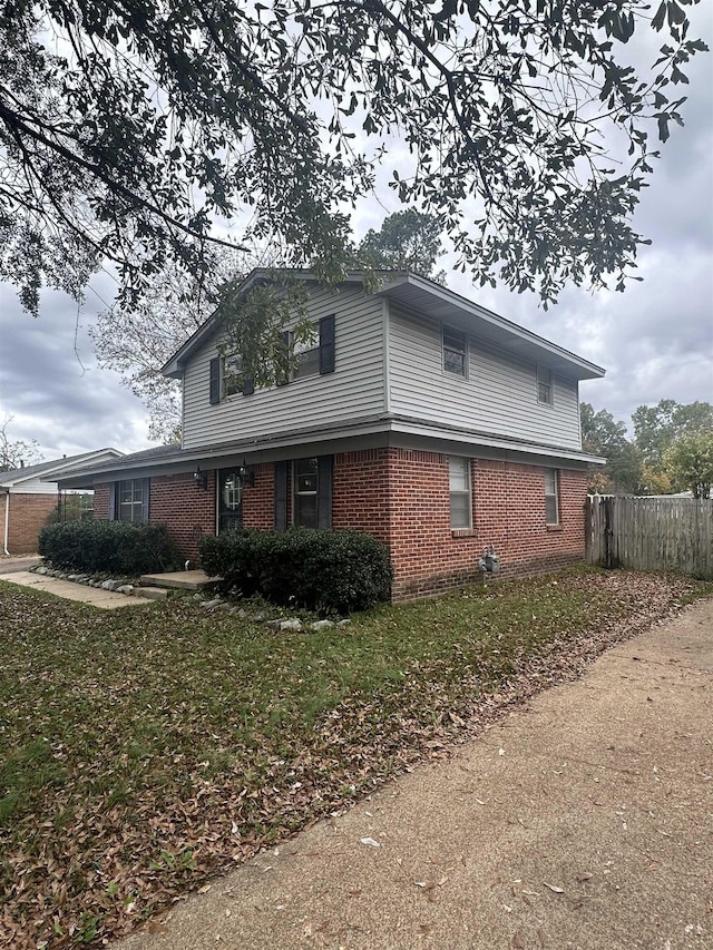 view of property exterior with a yard