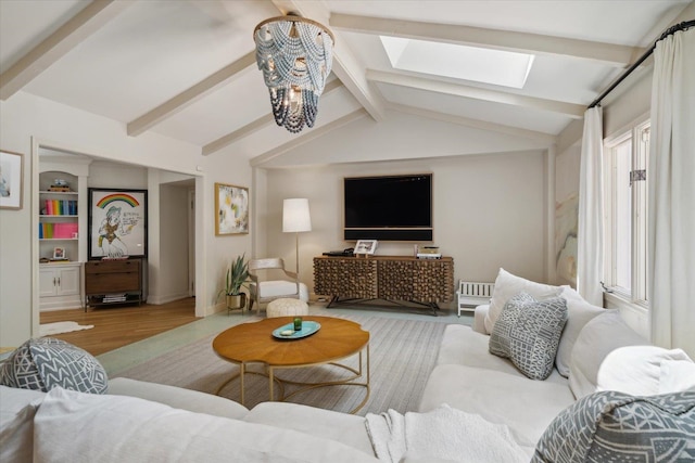 living room featuring hardwood / wood-style flooring, lofted ceiling with skylight, and plenty of natural light