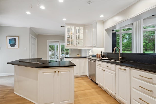 kitchen featuring white cabinets, light wood-type flooring, and dishwasher