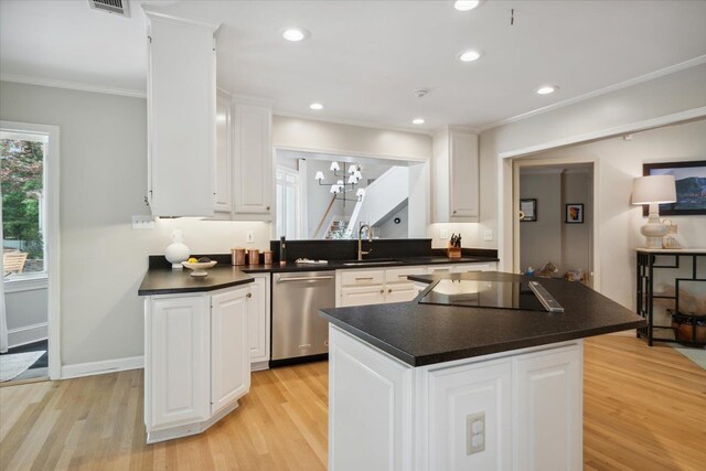 kitchen featuring white cabinets, a kitchen island, stainless steel dishwasher, and light hardwood / wood-style floors