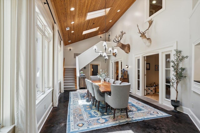 dining area with a skylight, high vaulted ceiling, and wooden ceiling