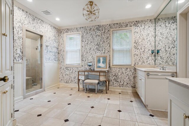 bathroom with vanity, a shower with door, a wealth of natural light, and crown molding