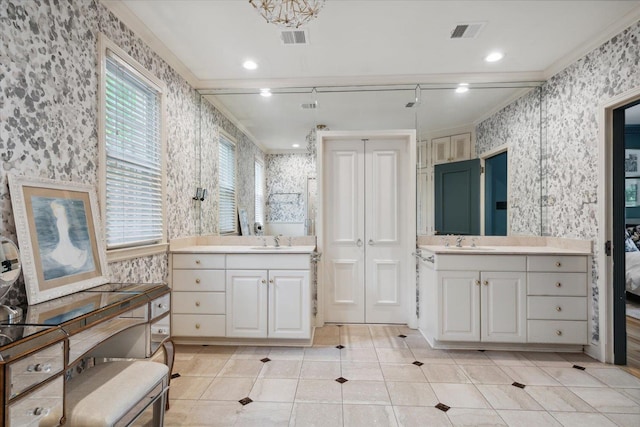 bathroom featuring tile patterned floors, vanity, ornamental molding, and a wealth of natural light