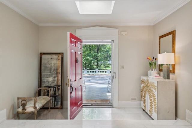 entrance foyer with ornamental molding and a skylight